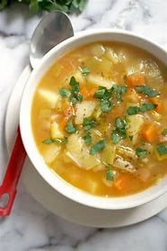 Bowl of vegetable soup with fresh herbs